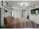 Spacious bedroom features a bed with decorative pillows, windows, and mounted TV at 4605 Clairmont Dr, Columbus, IN 47203