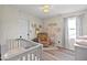 Cozy Bedroom featuring crib, rocking chair, and soft decor, creating a calm and inviting space at 4605 Clairmont Dr, Columbus, IN 47203
