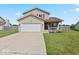 Charming two-story home with a well-manicured lawn and a two-car garage, perfect for suburban living at 4605 Clairmont Dr, Columbus, IN 47203