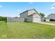 Exterior image showcasing a two-story home with an attached garage and fenced yard on a sunny day at 4605 Clairmont Dr, Columbus, IN 47203