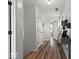 Hallway featuring wood-look floors, white walls and trim, and contemporary decorations at 4605 Clairmont Dr, Columbus, IN 47203