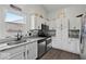 Modern kitchen featuring stainless steel appliances, granite countertops, and white cabinets for a clean design at 4605 Clairmont Dr, Columbus, IN 47203