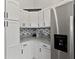 Organized pantry with white cabinetry, granite countertops, and modern appliances for convenient storage at 4605 Clairmont Dr, Columbus, IN 47203