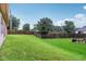 Large, well-maintained backyard with lush green grass and a wooden privacy fence at 4933 Common Vista Way, Indianapolis, IN 46220