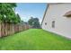 Side yard view showcasing a well-maintained lawn and privacy fence at 4933 Common Vista Way, Indianapolis, IN 46220