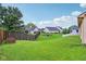 Spacious backyard with lush green lawn, wooden fence, and mature trees providing privacy at 4933 Common Vista Way, Indianapolis, IN 46220