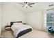 Bright bedroom with a modern bed, ceiling fan, and a cozy chair, offering comfort and style at 4933 Common Vista Way, Indianapolis, IN 46220