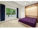 Bright bedroom with vaulted ceiling, large window, and sleek murphy bed with purple bedspread at 4933 Common Vista Way, Indianapolis, IN 46220