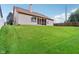 Exterior view of home with a well-manicured backyard featuring a gentle slope and screened-in porch at 4933 Common Vista Way, Indianapolis, IN 46220