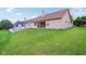 Exterior home view showcases a backyard with a privacy fence and well-kept lawn at 4933 Common Vista Way, Indianapolis, IN 46220