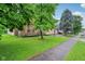 A view of the front exterior and lawn of the home from the street sidewalk at 4933 Common Vista Way, Indianapolis, IN 46220