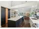 Spacious kitchen leading into dining and living areas with a large island and modern appliances at 4933 Common Vista Way, Indianapolis, IN 46220