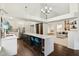 Open kitchen featuring a large island with seating and views into a bright living room at 4933 Common Vista Way, Indianapolis, IN 46220