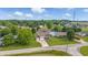 Scenic aerial view of home with a well-manicured lawn and attached two-car garage in a lush, green neighborhood at 5030 E 800 N, Columbus, IN 47203