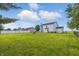 Expansive backyard featuring a large lawn, surrounded by a fence and trees, offering ample space for outdoor activities at 5030 E 800 N, Columbus, IN 47203