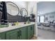 Well-lit bathroom showcasing double sinks, black accents, and view into the bedroom at 5030 E 800 N, Columbus, IN 47203