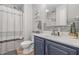 Well-lit bathroom featuring stylish vanity with sink and cabinet storage beneath a mirror and decorative gray tiled backsplash at 5030 E 800 N, Columbus, IN 47203