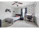 Nicely decorated bedroom with a gaming controller wall hanging, study desk, ceiling fan, and patterned wallpaper at 5030 E 800 N, Columbus, IN 47203
