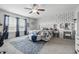 Bright bedroom showcasing a king bed, vanity, natural light, ceiling fan, and stylish decor at 5030 E 800 N, Columbus, IN 47203