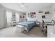 Comfortable bedroom featuring a bed, a desk and chair, and windows providing natural light, creating a cozy atmosphere at 5030 E 800 N, Columbus, IN 47203
