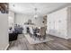 The dining room features modern lighting, wood floors, fireplace and ample built in storage at 5030 E 800 N, Columbus, IN 47203