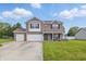 Charming two-story brick home with a three-car garage and well-manicured lawn at 5030 E 800 N, Columbus, IN 47203
