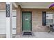 Close-up of the front door with a welcome mat and decorative wreath at 5030 E 800 N, Columbus, IN 47203