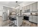 Modern kitchen featuring stainless steel appliances, kitchen island with bar seating, and gray cabinets at 5030 E 800 N, Columbus, IN 47203
