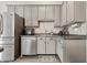 Kitchen featuring stainless steel appliances, gray cabinets, granite countertops and tiled backsplash at 5030 E 800 N, Columbus, IN 47203