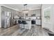 Modern kitchen with stainless steel appliances, gray cabinets, and kitchen island with barstool seating at 5030 E 800 N, Columbus, IN 47203