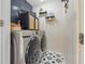 Modern laundry room with front-load washer and dryer, patterned tile floor, and storage cabinets at 5030 E 800 N, Columbus, IN 47203