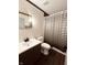 Modern bathroom with black-and-white striped shower curtain and elegant vanity at 514 W 6Th St, Sheridan, IN 46069