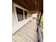 View of the covered porch offering a seating area, wooden decking, and an inviting entrance to the home at 514 W 6Th St, Sheridan, IN 46069