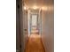 Hallway featuring wood flooring and white walls, leading to rooms with paneled doors at 514 W 6Th St, Sheridan, IN 46069