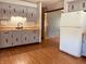 Kitchen with grey cabinets, stainless steel sink, and white refrigerator at 514 W 6Th St, Sheridan, IN 46069