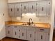 Traditional kitchen features light grey cabinetry, butcher block counters, and modern black fixtures at 514 W 6Th St, Sheridan, IN 46069