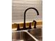 Modern black faucet detail over a stainless steel kitchen sink, complemented by a white tiled backsplash at 514 W 6Th St, Sheridan, IN 46069