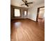 Open living room with a ceiling fan, two windows and beautiful laminate flooring at 514 W 6Th St, Sheridan, IN 46069