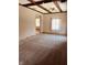 Bright living room featuring beamed ceiling, neutral walls, and plush carpeting at 514 W 6Th St, Sheridan, IN 46069