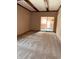 Open living room boasts beamed ceiling, neutral walls, and plush carpeting at 514 W 6Th St, Sheridan, IN 46069