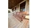 Close up of a porch swing on a covered porch with natural wood decking, offering a relaxing outdoor experience at 514 W 6Th St, Sheridan, IN 46069