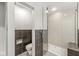 Modern bathroom with tiled walls, a glass-enclosed shower, and sleek fixtures at 518 Buckingham Dr, Indianapolis, IN 46208