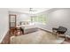 Bright bedroom with hardwood floors, many windows, and comfortable chair at 518 Buckingham Dr, Indianapolis, IN 46208
