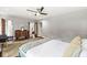 Spacious bedroom with wooden floors, a dresser, and multiple doorways at 518 Buckingham Dr, Indianapolis, IN 46208