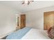 Cozy bedroom featuring a ceiling fan, neutral walls, and a glimpse into another room at 518 Buckingham Dr, Indianapolis, IN 46208