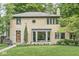 Attractive brick house with a well-kept lawn, tasteful landscaping, and modern windows at 518 Buckingham Dr, Indianapolis, IN 46208