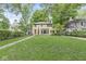 Charming two-story brick home featuring a well-manicured lawn and mature trees in a desirable neighborhood at 518 Buckingham Dr, Indianapolis, IN 46208
