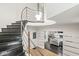Grand foyer featuring a curved staircase with metal railing, high ceilings, and hardwood floors at 518 Buckingham Dr, Indianapolis, IN 46208
