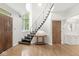 Bright foyer with an open staircase and curved ceiling above highlights the entryway's unique style at 518 Buckingham Dr, Indianapolis, IN 46208