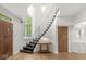 Bright foyer with an open staircase and curved ceiling above highlights the entryway's unique style at 518 Buckingham Dr, Indianapolis, IN 46208